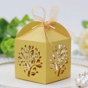 Detailed laser-cut tree design on yellow gift box with elegant organza ribbon