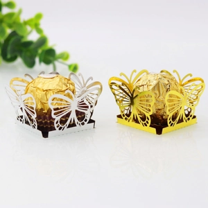 Macro shot of laser-cut hollow butterfly candy boxes in gold and silver finish