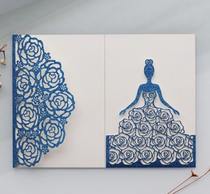 Detail of laser-cut rose patterns and glitter silhouette on navy blue invitation