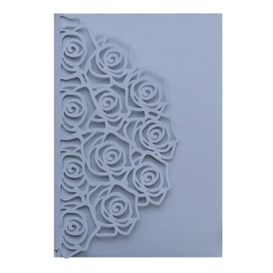 Detailed laser-cut rose pattern on light blue pearlescent paper wedding invitation card