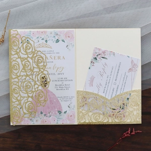 Macro view of laser-cut glitter wedding invitation with pink floral princess theme