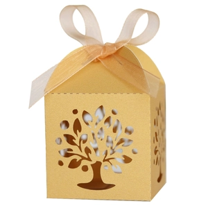 Detailed laser-cut tree of life design on gold pearlescent paper favor box with ribbon