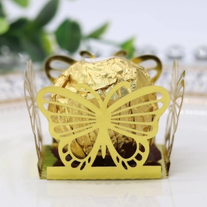 Detailed view of golden laser-cut butterfly chocolate box for wedding parties