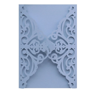 Laser cut light blue pearlescent paper invitation with intricate floral vine patterns
