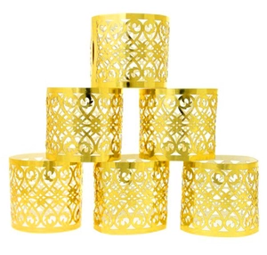 Macro detail of six hollow gold napkin rings with laser-cut heart patterns