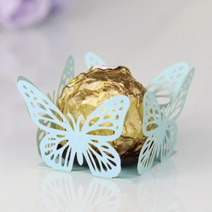 Macro shot of laser-cut light blue butterfly hollow chocolate wrapper for parties