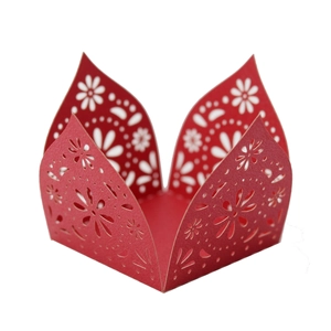 Macro view of red laser-cut candy box with floral patterns and scalloped edges