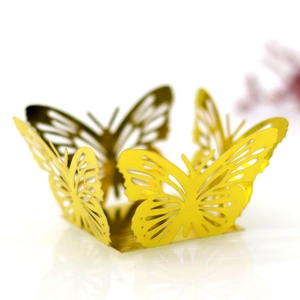 Close-up of golden hollowed butterfly wrapper for cupcakes and party favors