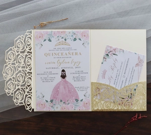 Detailed close-up of laser-cut cream rose invitation with gold glitter and floral card