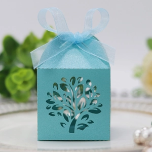 Detail of light blue laser-cut tree gift box with a matching ribbon bow for parties