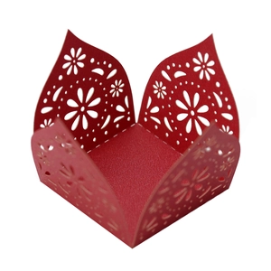 Close-up of laser-cut red paper candy box featuring intricate floral patterns for weddings