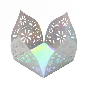 Close-up of laser-cut iridescent hollow daisy paper wrapper for candy box decoration