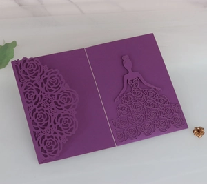 Detail of laser-cut rose lace and elegant girl silhouette on purple invitation card