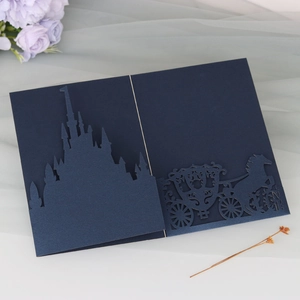 Intricate laser-cut blue card featuring a majestic castle and fairy-tale pumpkin carriage