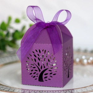 Detail of laser-cut Tree of Life candy box in purple with elegant organza ribbon bow