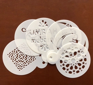 Macro detail of PET cake stencils with Umrah Mubarak lettering and star moon patterns