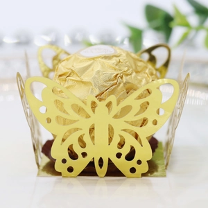 Macro shot of gold laser-cut butterfly chocolate wrapper for wedding party favor decoration