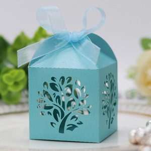 Detailed laser-cut tree design on light blue pearl paper gift box with ribbon