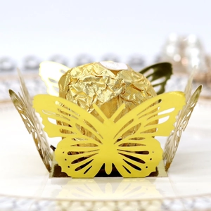 Close-up of golden hollow butterfly lace wrapper for party chocolate decoration