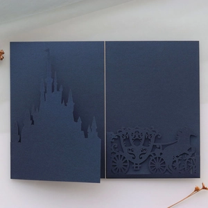 Detailed laser cut dark blue invitation card with castle and pumpkin carriage designs