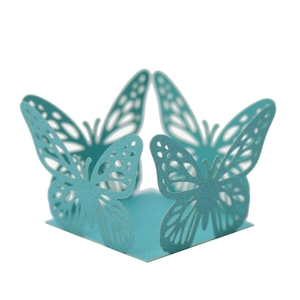 Detail of teal butterfly laser-cut lace cupcake wrappers for birthday party favors