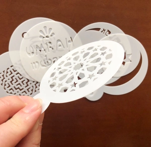 Detail of laser-cut moon and star cake stencils for Umrah Mubarak festive decorations