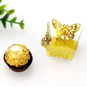 Detail of gold laser-cut butterfly chocolate wrapper with square base and intricate hollows