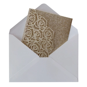 Detail of glitter gold rose laser-cut wedding invitation with premium white envelope