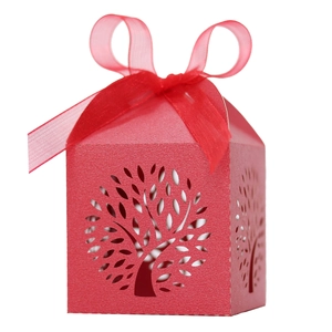 Detail of red laser-cut Tree of Life wedding favor box with an elegant sheer ribbon bow