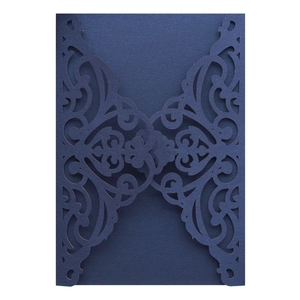 Detailed laser-cut navy blue pearlescent paper invitation cover with elegant floral motifs