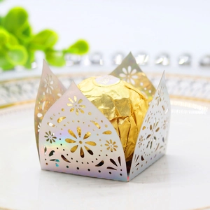 Macro view of laser-cut gold hollow candy box with iridescent laser paper flower patterns