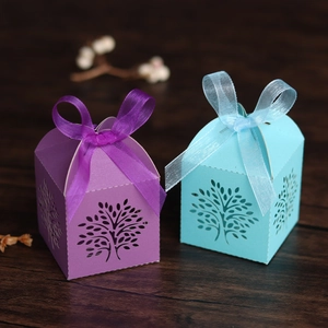 Detailed laser-cut tree design on purple and light blue cardstock party favor boxes