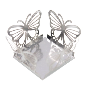 Macro detail of silver mirror laser-cut hollow butterfly wedding favor candy box