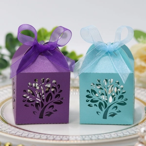 Detail of laser-cut tree design gift boxes with ribbons in light blue and purple colors