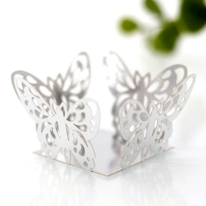 Macro shot of laser-cut white butterfly lace decoration with delicate pearlescent finish