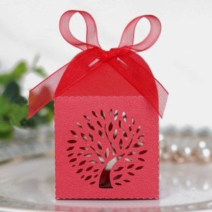 Detail of red laser-cut Tree of Life candy box with an elegant organza ribbon bow