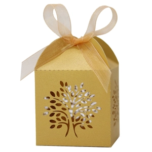 Detailed laser-cut tree pattern on a golden gift box with a matching organza ribbon bow