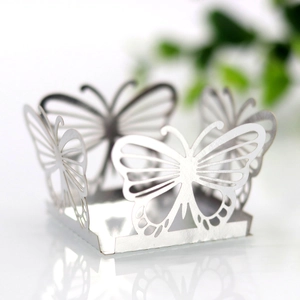 Macro shot of white laser-cut butterfly hollow candy box with pearlescent finish