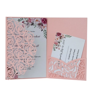 Laser cut light pink wedding invitation set with intricate rose floral pocket and cards