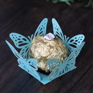 Macro detail of laser-cut butterfly candy box in light blue pearlescent paper