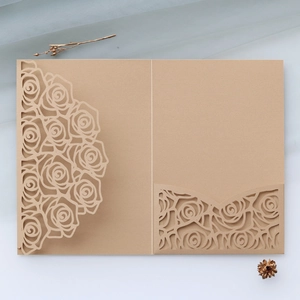 Detailed laser-cut rose floral wedding invitation sleeve in rustic kraft paper finish