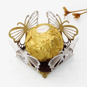 Macro shot of silver laser-cut butterfly candy box with mirror finish for parties