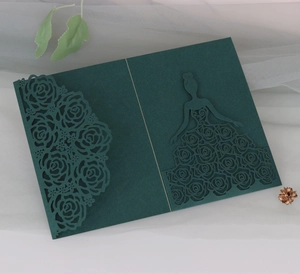 Detail of laser cut wedding invitation showing intricate dark green rose patterns