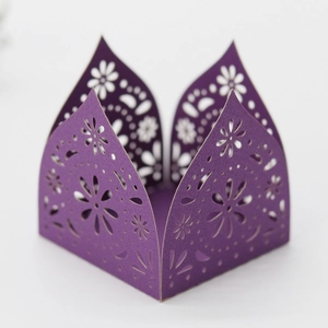Macro detail of purple laser-cut candy box featuring intricate floral lace hollow patterns