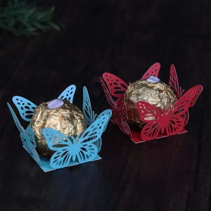 Detailed laser-cut butterfly candy liners in sky blue and red for party favors