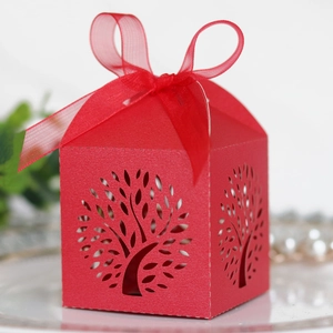 Detail of red laser-cut Tree of Life candy box with a large sheer organza ribbon bow