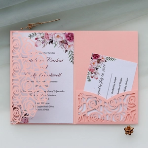 Detail of pink laser-cut rose wedding invitation set with floral inner cards and RSVP
