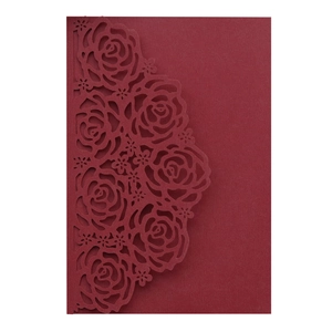 Detail of laser-cut burgundy rose patterns on high-quality matte paper invitation card