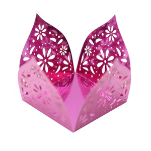 Macro detail of laser-cut rose red floral cupcake wrapper with metallic mirror finish