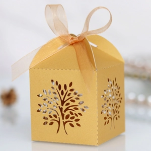 Detailed macro view of golden laser-cut tree gift box with elegant organza ribbon